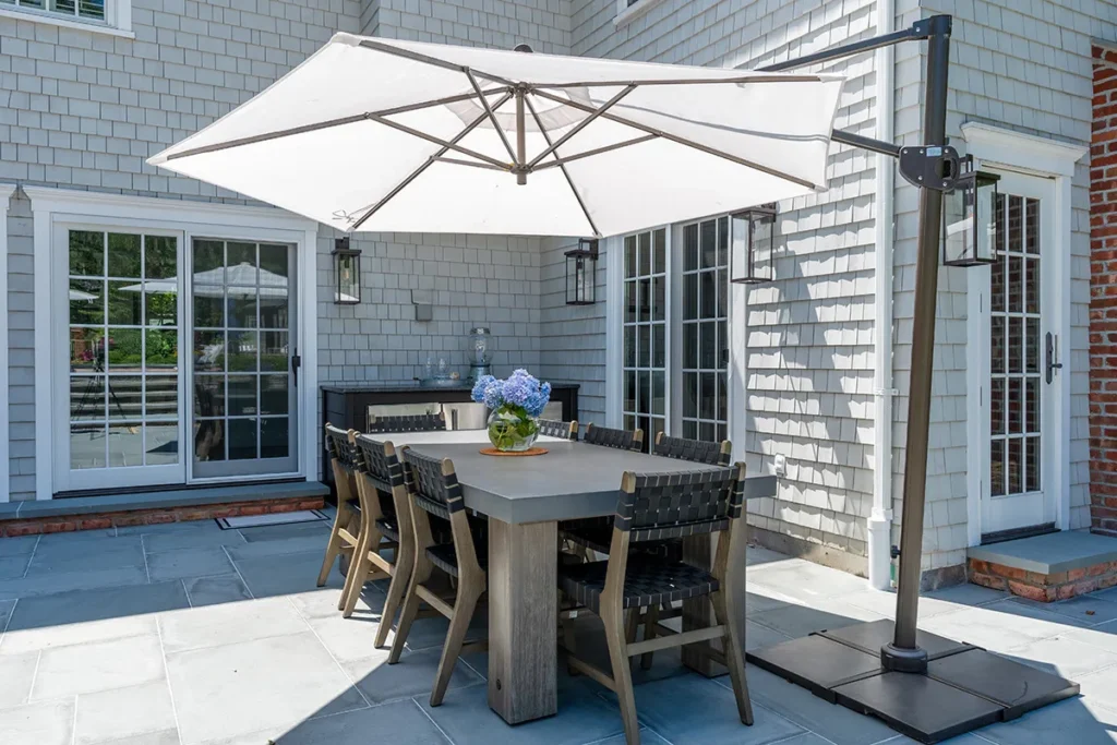 Stone-top outdoor kitchen island on a bluestone patio