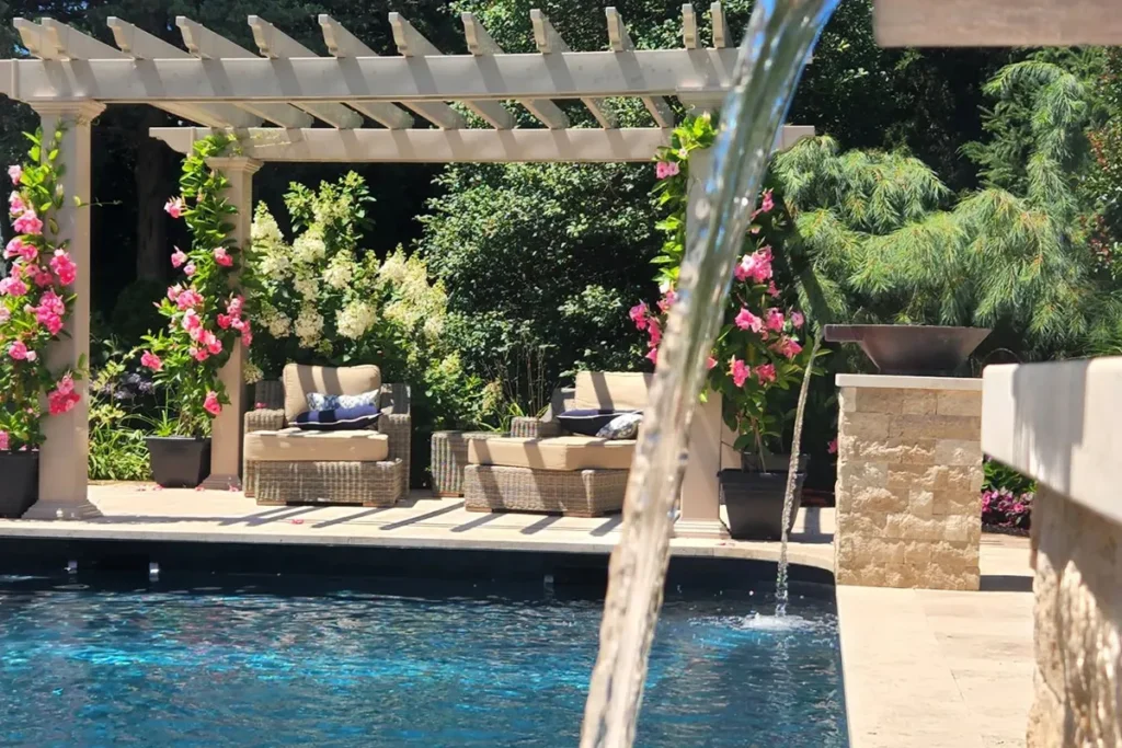 Pergola-covered patio next to a pool