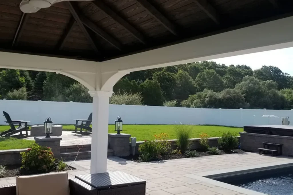 Covered pavilion overlooking a pool at dusk