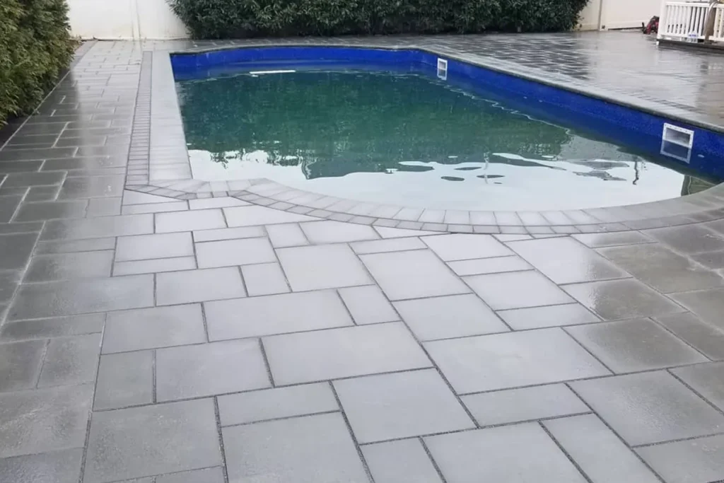 Close-up texture of a wet paver pool deck