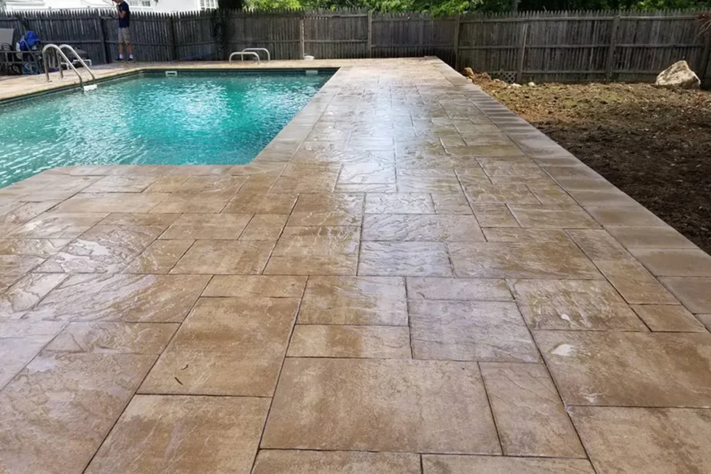 Pool deck renovated with tumbled travertine pavers, detail view