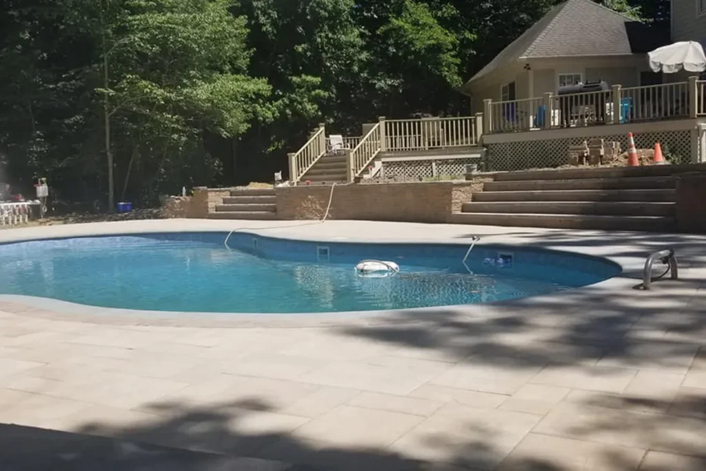 Renovated pool with travertine-style paver patio deck