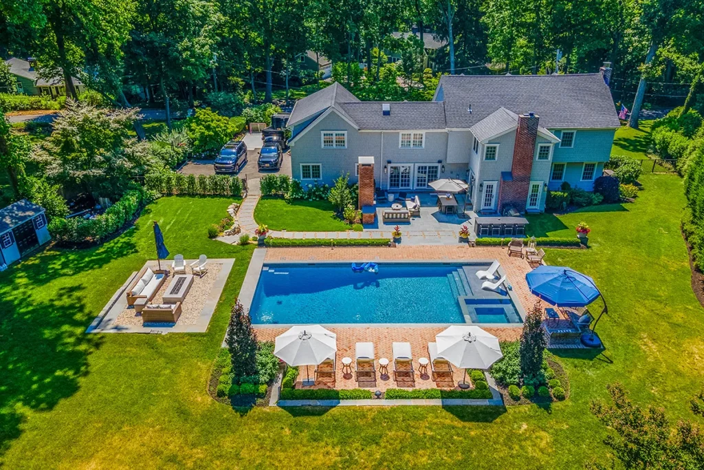 Aerial view of a custom inground pool with paver patio